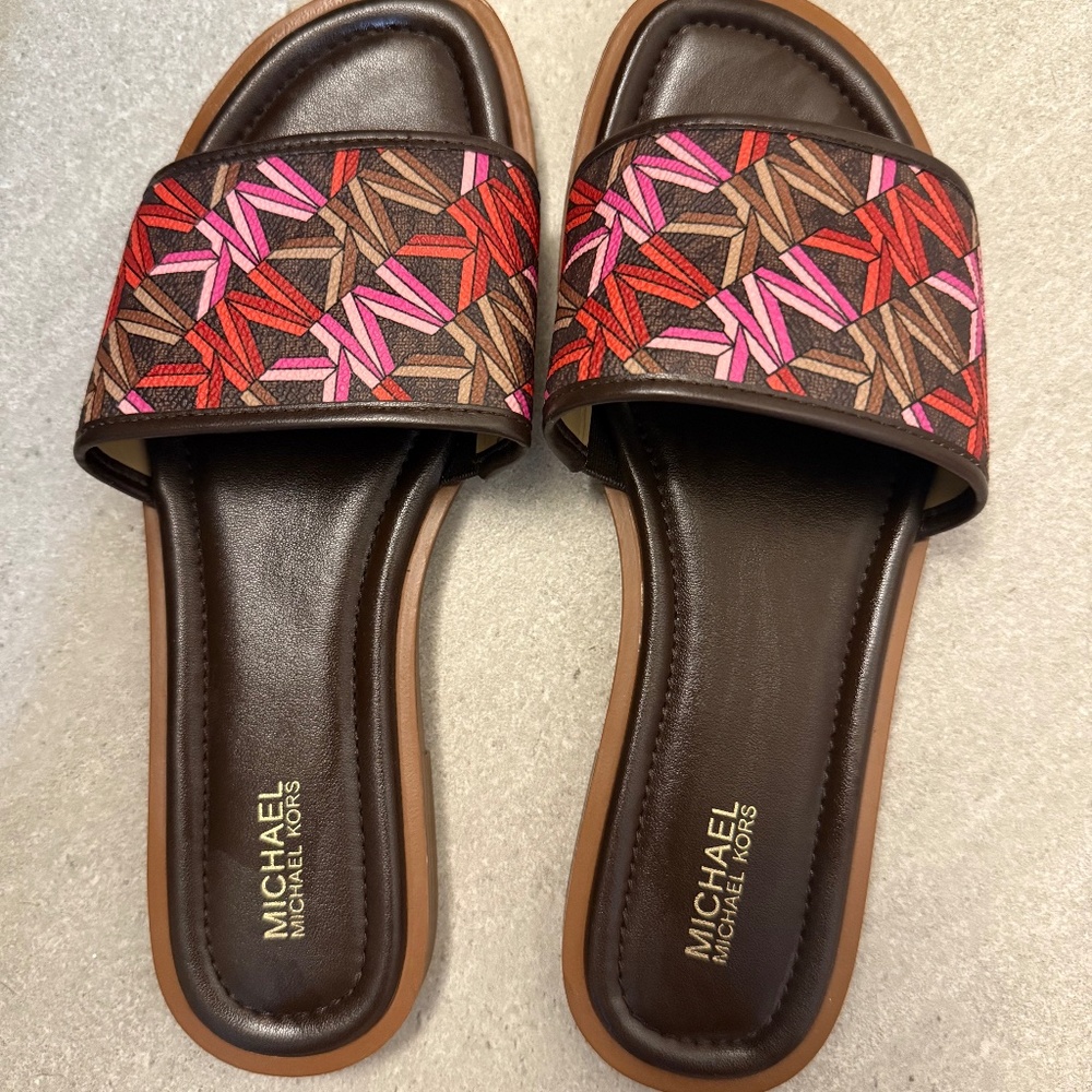Michael Kors slide sandals in dark brown with pink emblems